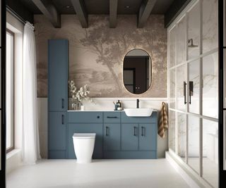 large bathroom with blue fitted units, white sink and toilet and large shower enclosure with doors