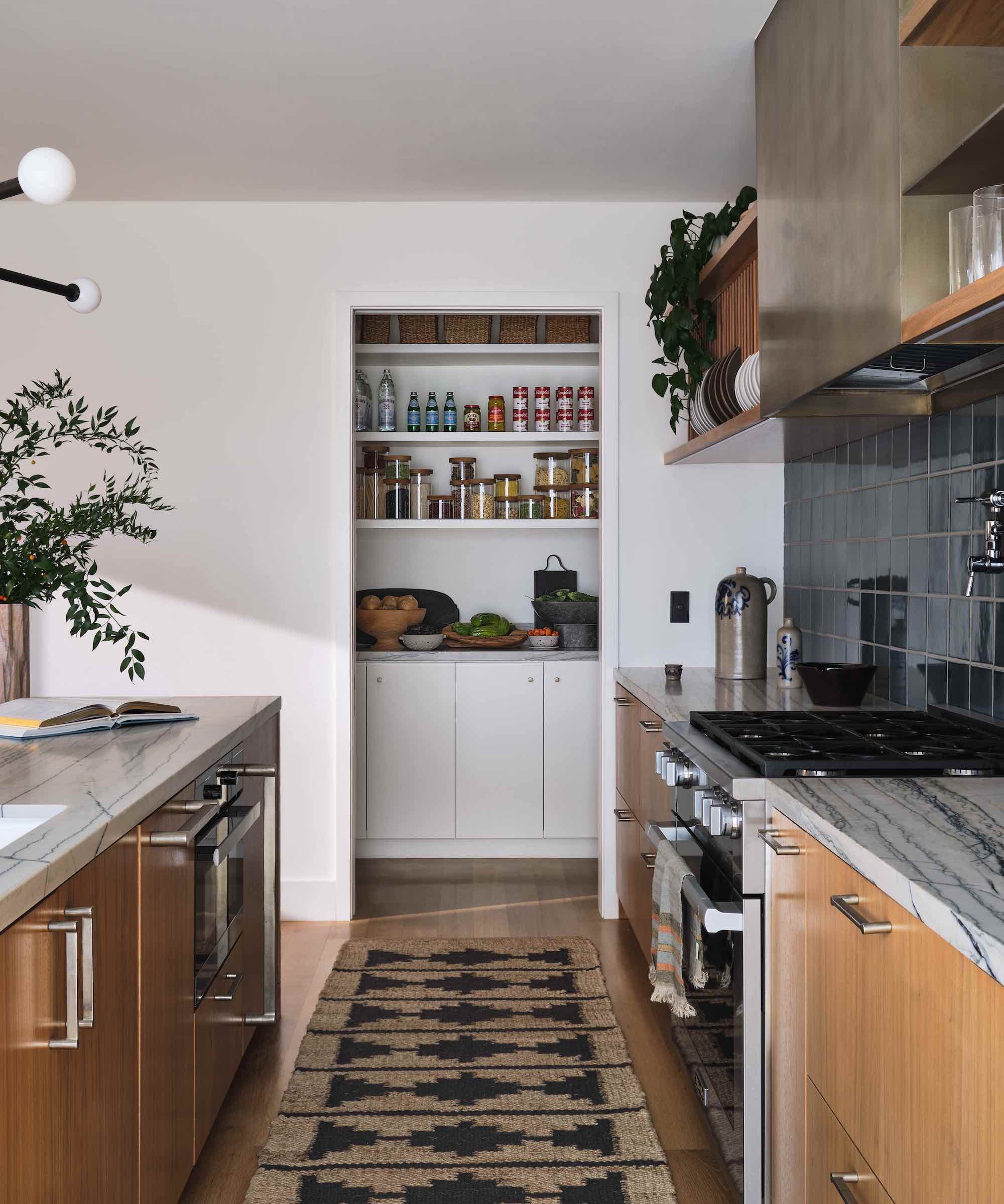 wood kitchen with white walk-in pantry