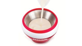 A red ZOKU ice cream maker with mix being poured into it