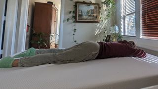 Member of testing panel lying on her stomach on PurpleFlex mattress