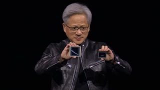 Jensen Huang holding two Nvidia Blackwell GPUs