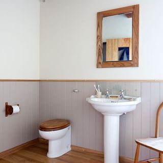 bathroom with mirror and wooden flooring