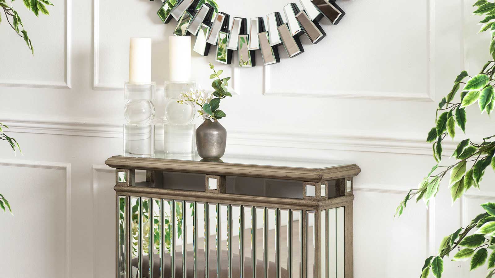 mirrored radiator cover in a white panelled hallway with candlesticks and vases displayed on the radiator cover shelf