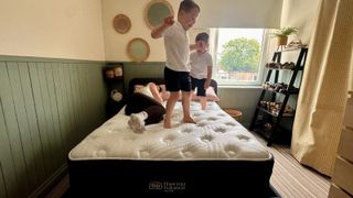 Our mattress reviewer carrying out motion isolation tests on the Brooklyn Bedding Thermobalance LX Elite