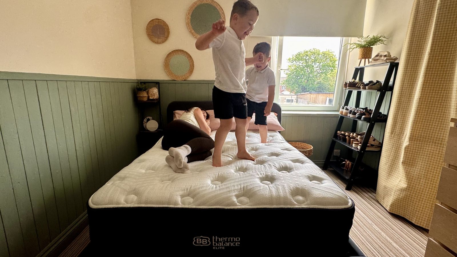 Our mattress reviewer carrying out motion isolation tests on the Brooklyn Bedding Thermobalance LX Elite 
