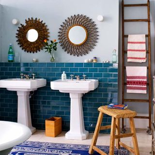 bathroom with sea blue tile wall and sinks