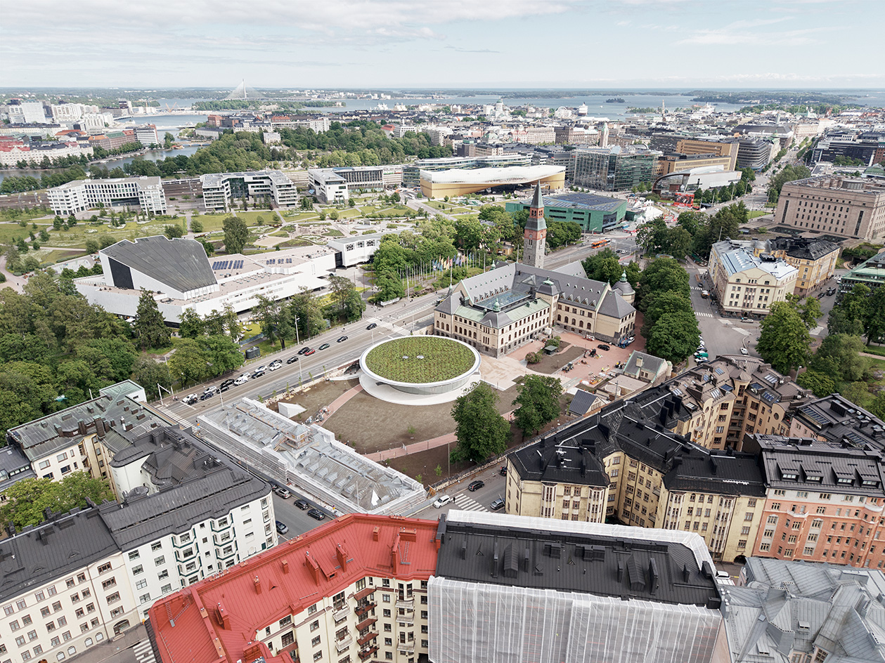JKMM - National Museum of Finland view of round, white and gold underground building next to the historical one