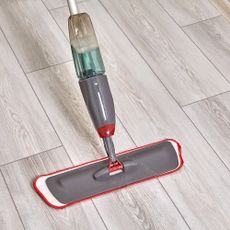 Grey spray mop on hard flooring