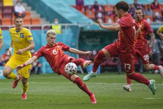 Ezgjan Alioski, centre, reacts to score the rebound after his penalty miss against Ukraine