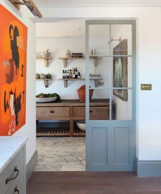 Walk-in pantry with wood flooring and cabinetry
