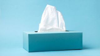 Box of tissues on blue background