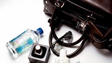 gum iphone sunglasses and other accessories spilling from a louis vuitton men&#039;s bag