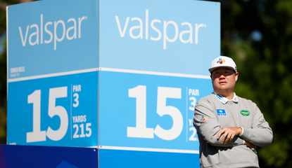 Sungjae Im stands in front of a Valspar Championship marker