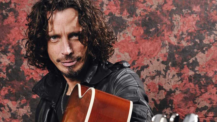 Chris Cornell holding an acoustic guitar in 2009