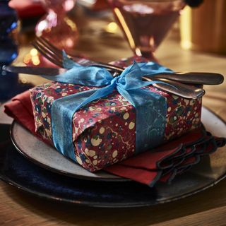 Christmas tablecsape with present with marbled wrapping paper.