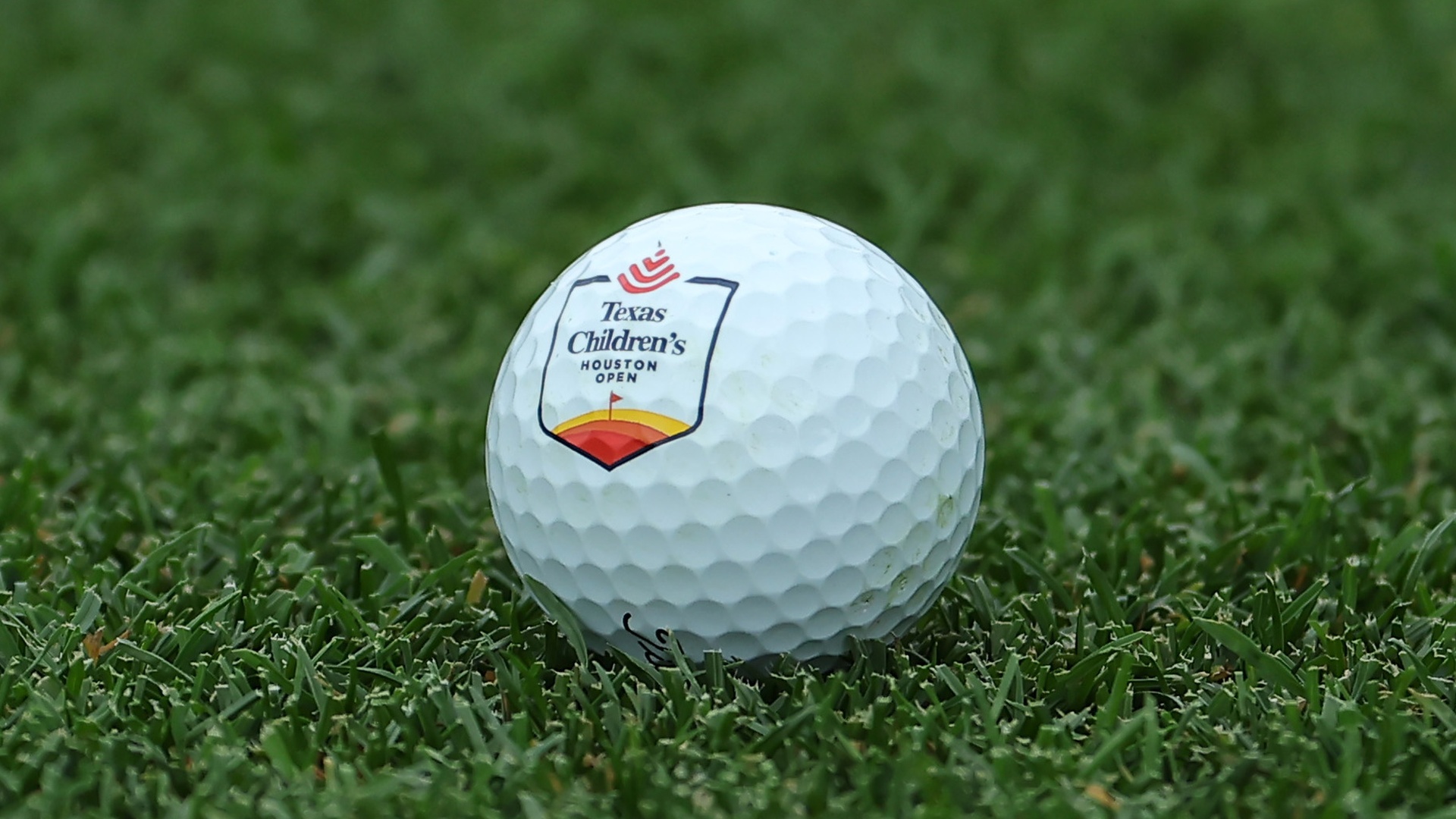 A golf ball emblazoned with the Houston Open crest at Memorial Park Golf Course