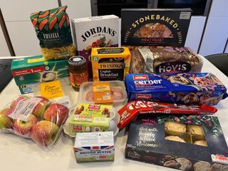 Sainsbury's supermarket haul laid out on a table including cereal, mince pies and pasta