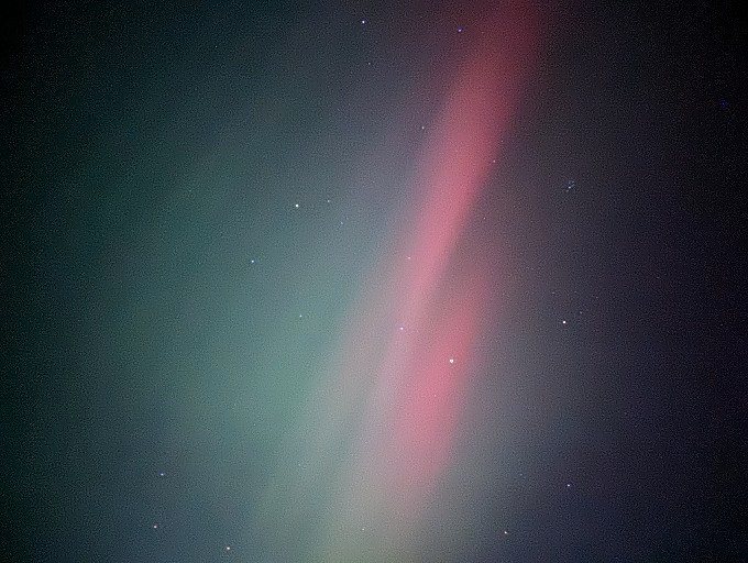 The Northern Lights' red and green pillars decorating the night sky