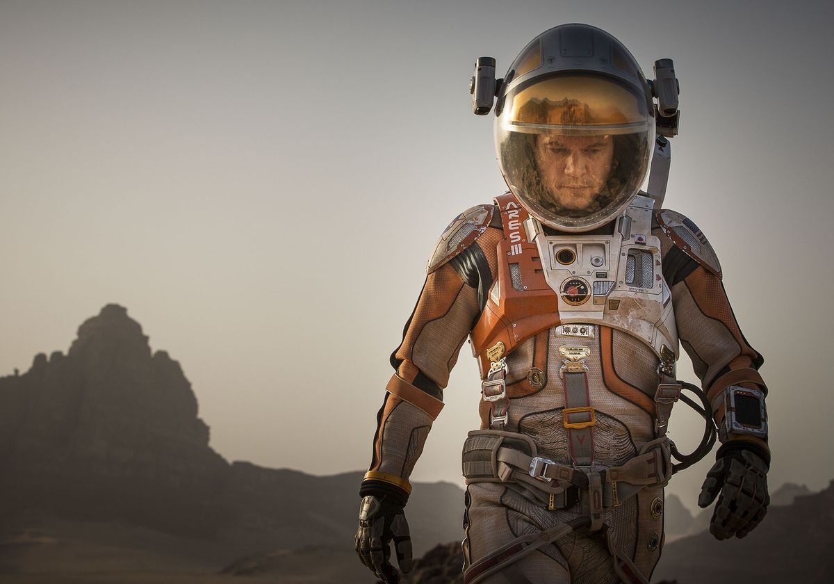 Matt Damon in a spacesuit walks on Mars