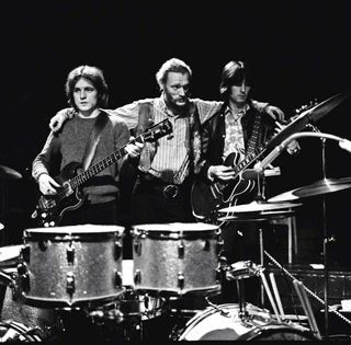 Jack Bruce, Ginger Baker and Eric Clapton from Cream pose together on stage during their farewell performance at the Royal Albert Hall in London on 26th November 1968.