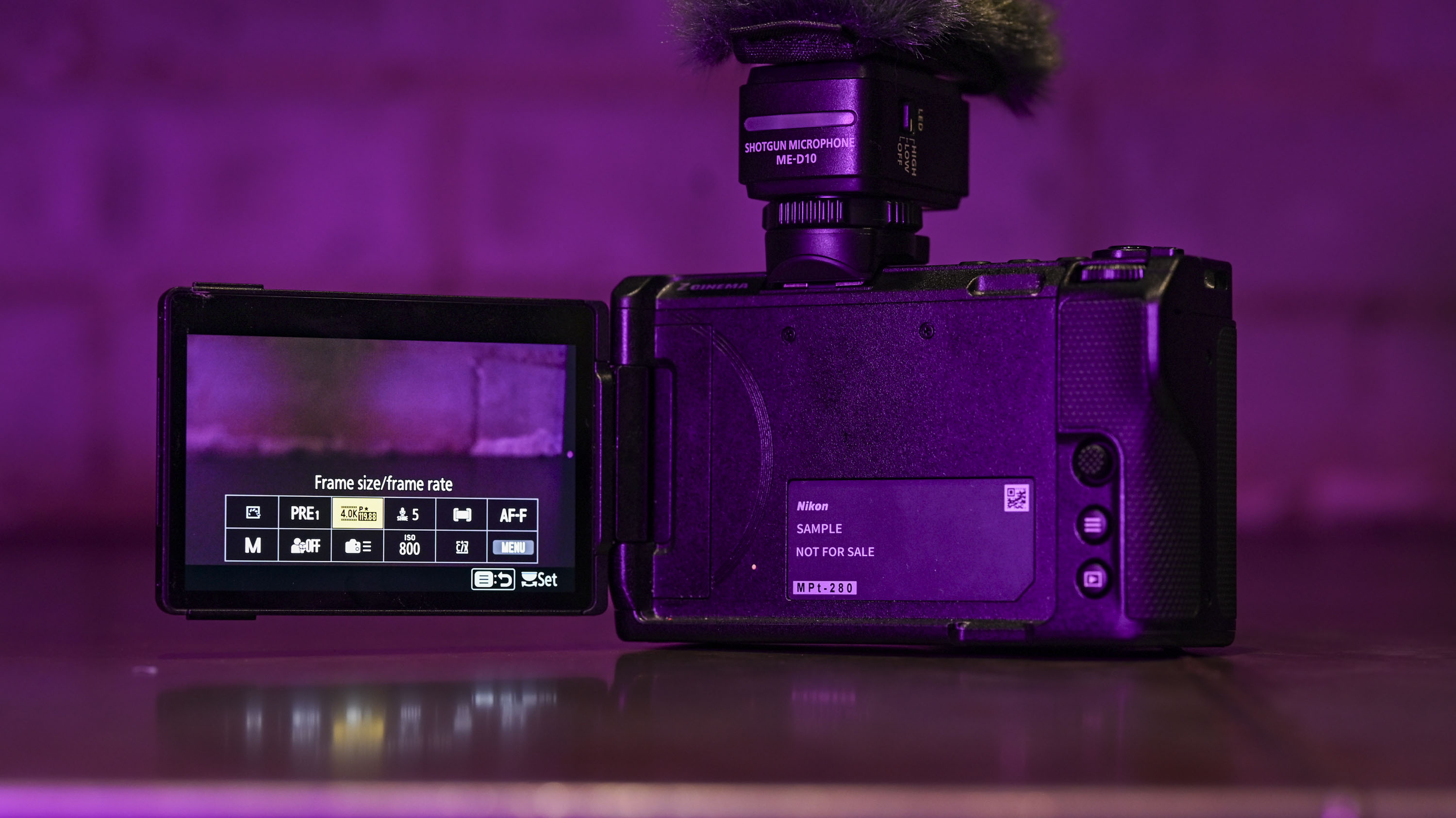 Nikon ZR camera with its screen flipped out, under low key magenta lighting