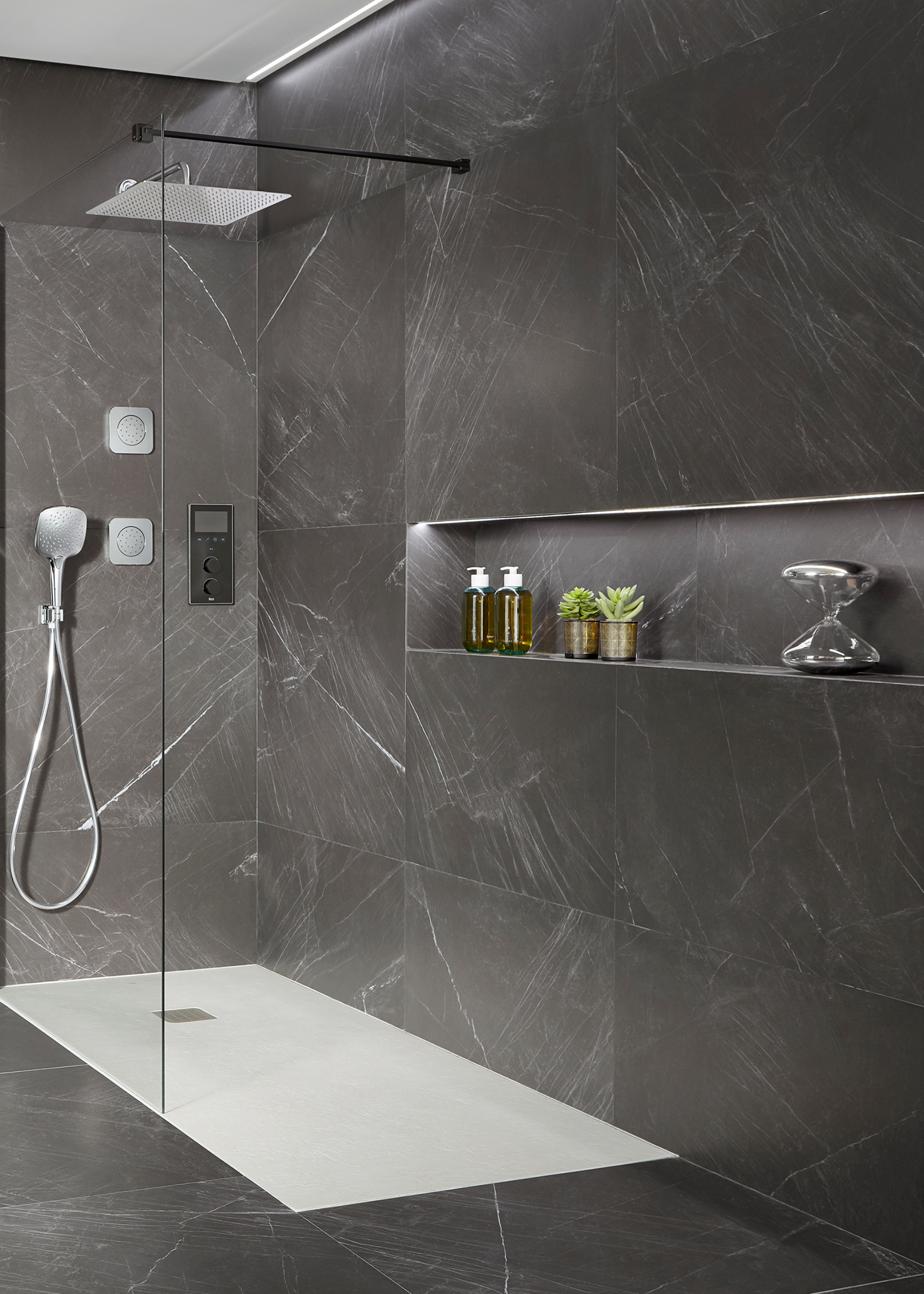 digital shower system in a dark grey stone shower