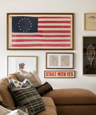 American style sitting room with american flag picture, brown suede sofa and plaid cushions