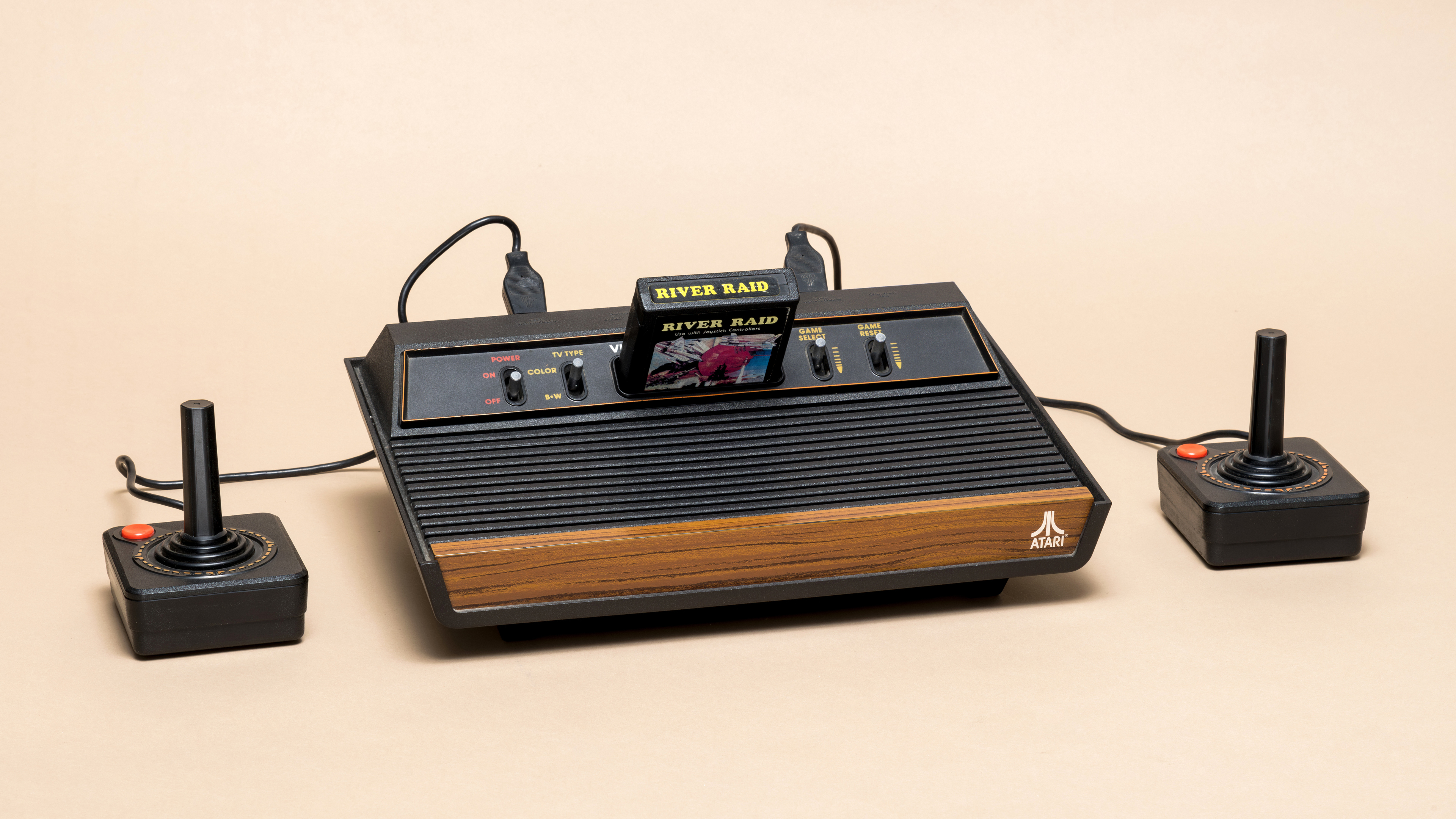 Pavia, Lombardy, Italy - November 23, 2024: Atari 2600 console from 1976 at Ctrl+Alt Museum. The cartridge, from 1982, is the shooter game River Raid.
