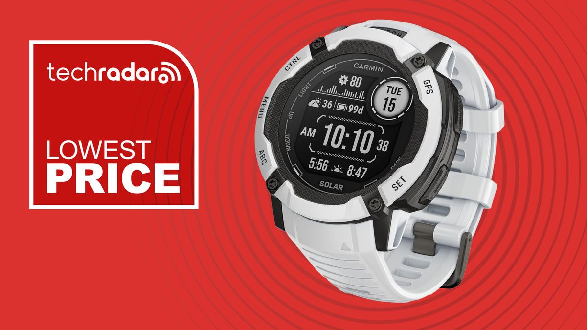 Garmin Instinct 2X Solar watch on red background with white text reading &quot;TechRadar lowest price&quot;