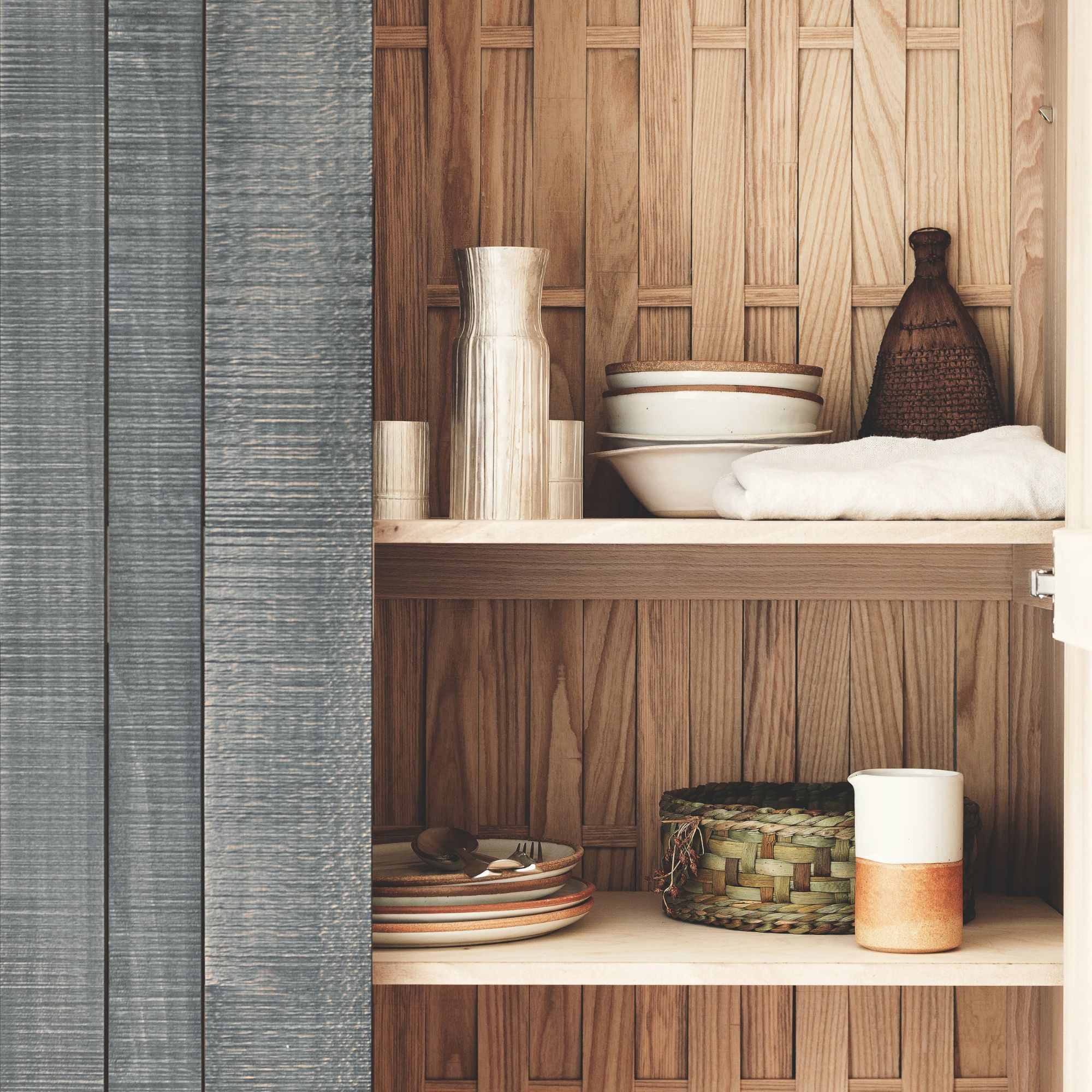 A wooden shelving unit with styled objects on show