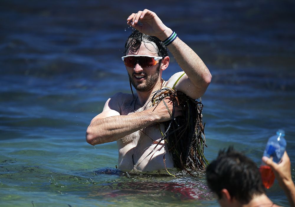 Nathan Haas of Australia and Team Katusha Alpecin cools off in the ocean after stage three of the 2018 Tour Down Under