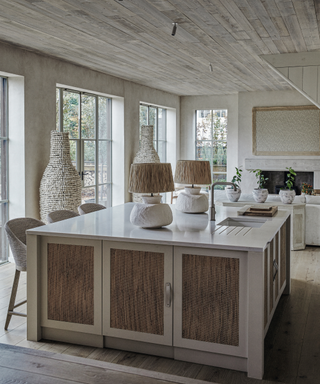kitchen with pale woode ceilings and lights with raffia shades in neutral palette