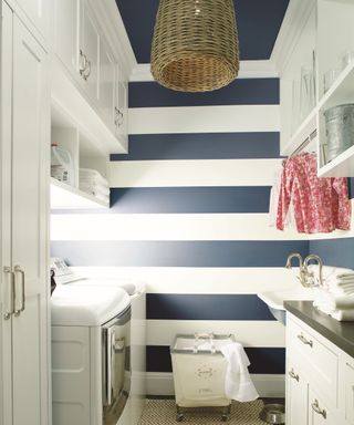 Small laundry room with graphic wide horizontal stripes painted on wall in monochrome shades