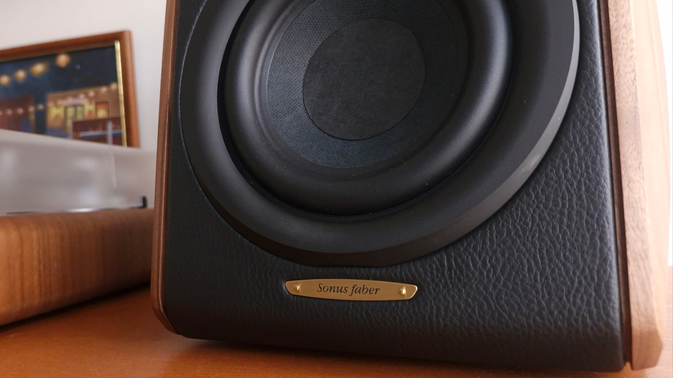 Close up of a Sonus Faber Concertino G4 bookshelf speaker, on a wooden surface