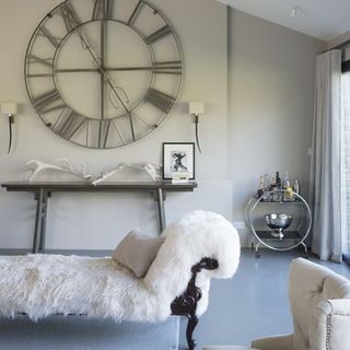 lounge area with slick drinks trolley and clock on wall
