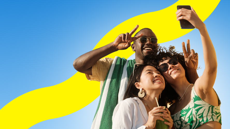 Three friends take a selfie together while on vacation