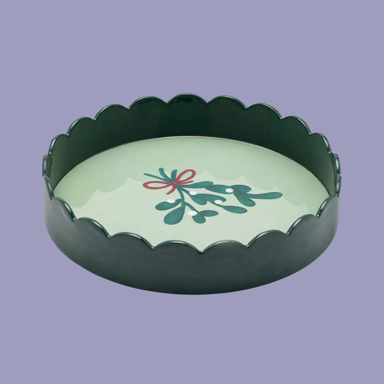 A scalloped tray with a mistletoe design