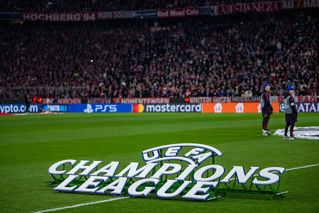 The Champions League logo on a pitch