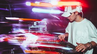 DJ stood behind decks with blurry light streaks