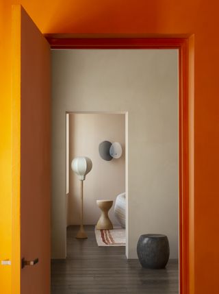 Interior of Pierre Yovanovitch showroom with orange and cream walls and various furniture designs