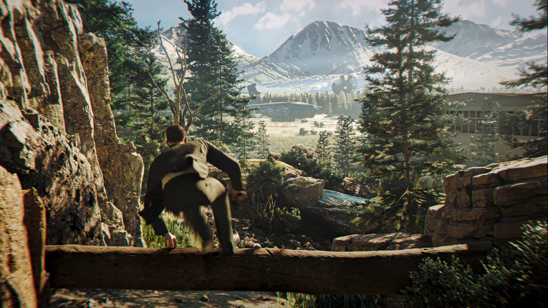 James Bond vaults a fallen tree in a forest in 007 First Light as he makes his way towards an airplane