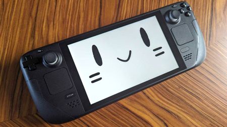 Steam Deck with mascot smiley face on screen