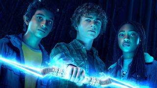 A promotional image showing Grover, Percy holding a lightning bolt, and Annabeth in Percy Jackson and the Olympians