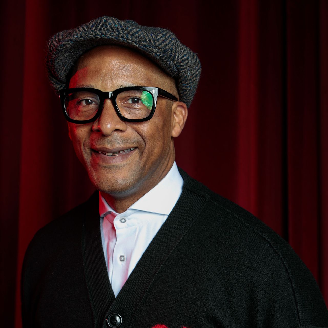 Headshot of Jay Blades against red backdrop