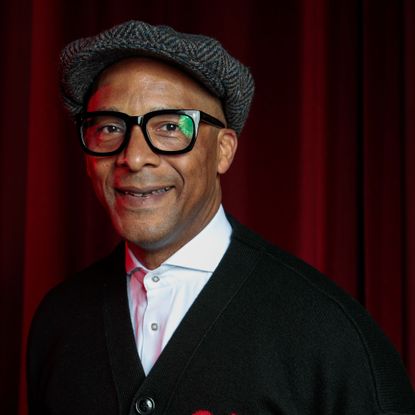 Headshot of Jay Blades against red backdrop