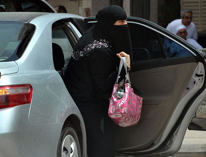 A Saudi woman exits a car in Riyadh.