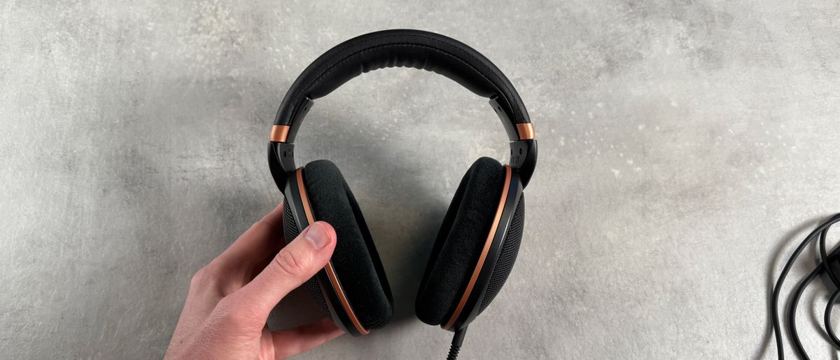 The Sennheiser HD 505 headphones held in a man&#039;s hand