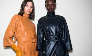 Both models are seen wearing wrap-around leather jackets with matching gloves, one in a bright orange, another in a navy.