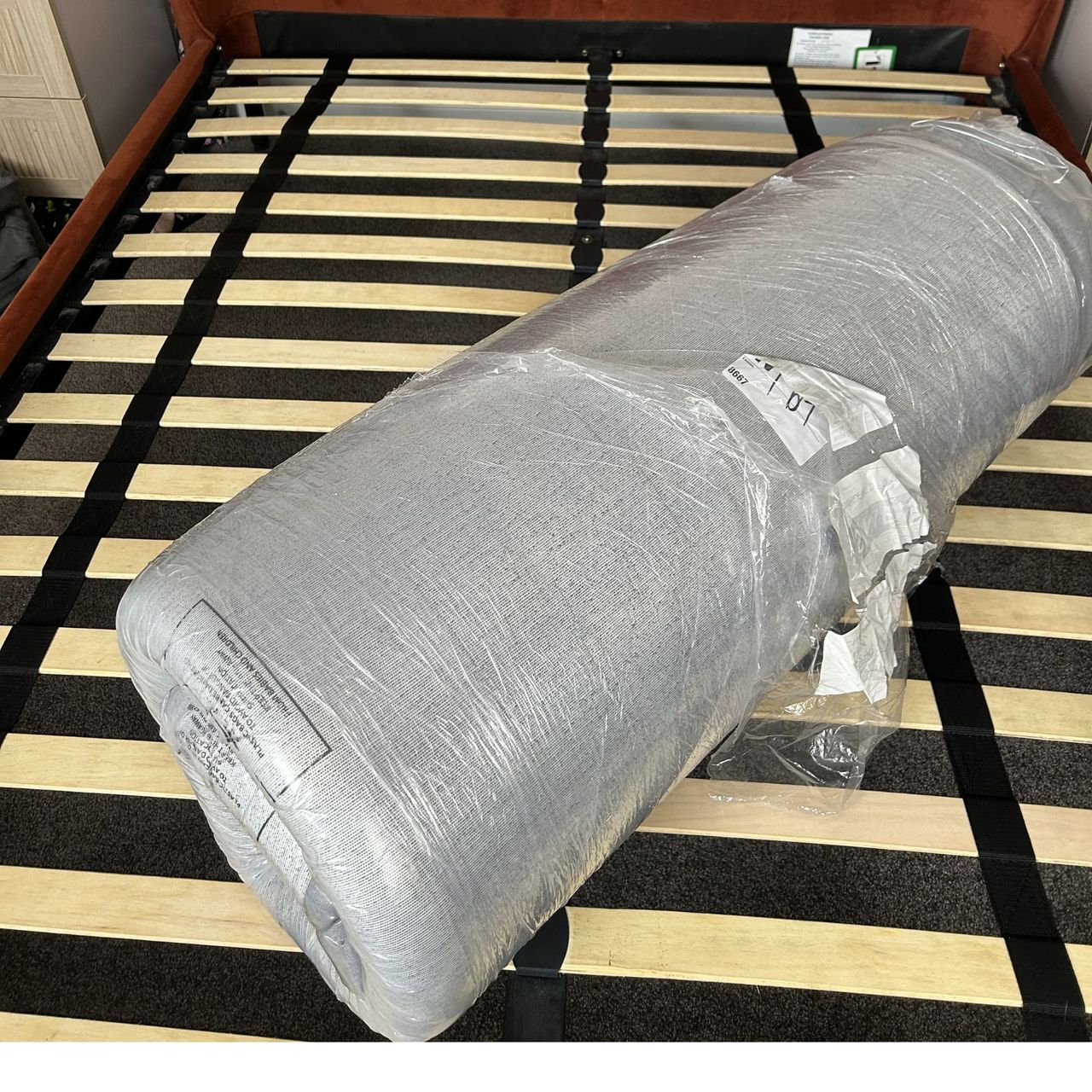 Simba mattress rolled and vacuum sealed on slatted bed base