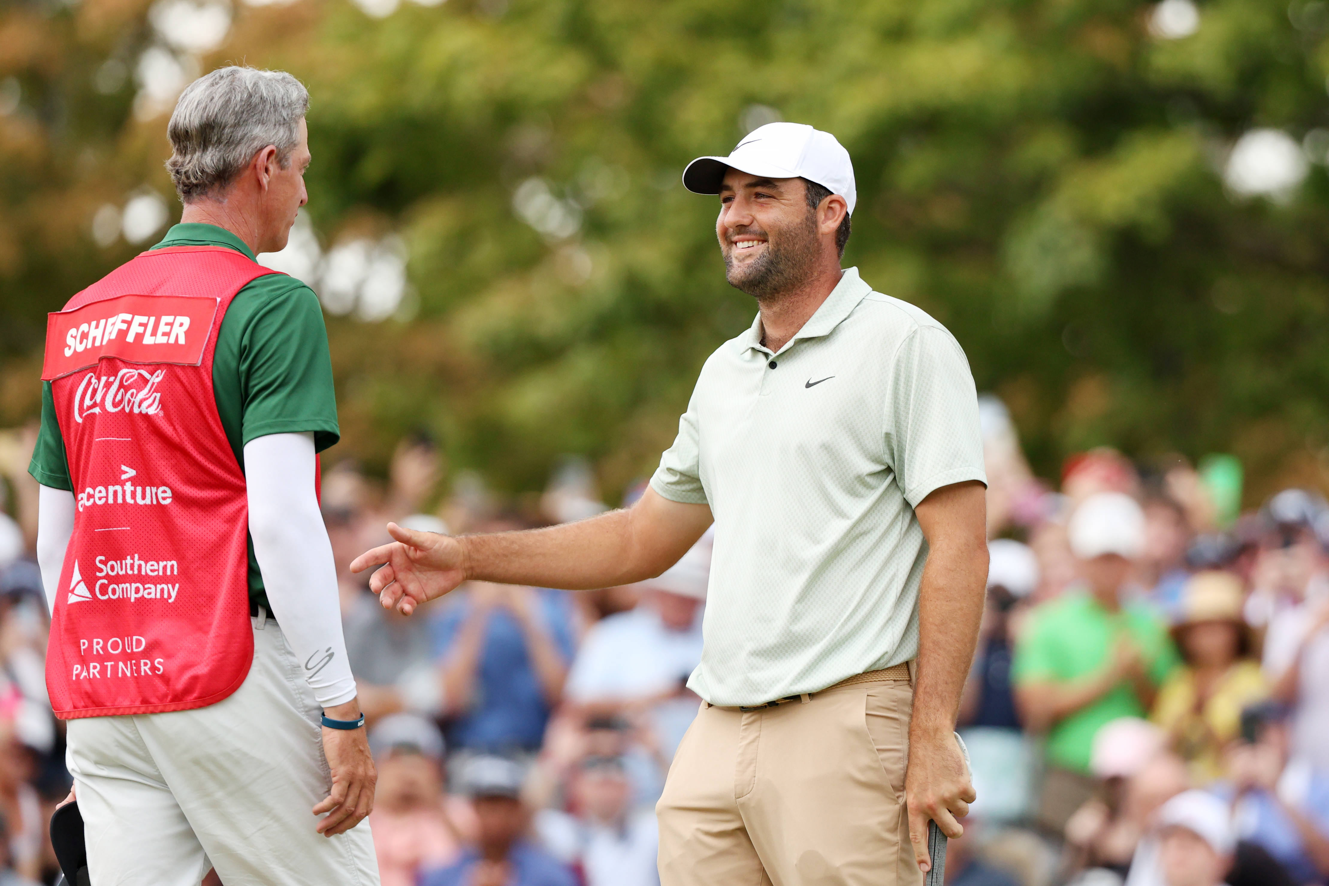 Scottie Scheffler hugs his caddie after winning the Tour Championship in 2024